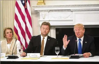  ?? STEPHEN CROWLEY / THE NEW YORK TIMES ?? President Donald Trump speaks to Republican senators about health care legislatio­n Wednesday at the White House. At left are Sen. Shelley Moore Capito, R-W.Va., who has said she was opposed to any plan that repeals the Affordable Care Act without a...