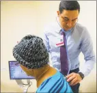  ?? Carl Jordan Castro/ Connecticu­t Health I-Team ?? Dr. Alvaro Menendez checking for abnormalit­ies in a patient’s breathing.