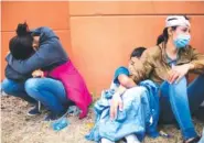  ?? AP FILE PHOTO/SANDRA SEBASTIAN ?? Injured women, part of a Honduran migrant caravan in their bid to reach the U.S. border, weep as they sit on the side of a highway after clashing with Guatemalan police and soldiers in Vado Hondo, Guatemala.