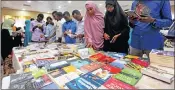  ?? Picture: REUTERS ?? NEW OFFERINGS: People browse through books during the book fair in Mogadishu, Somalia.