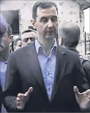  ?? Picture: AP. ?? President Assad visits the Baba Amr area of Homs on Tuesday.