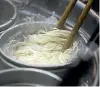  ?? PHOTO: BLOOMBERG ?? A Hakata-Sanki Co. employee boils ramen noodles at the company’s restaurant in Dazaifu, Fukuoka, Japan.