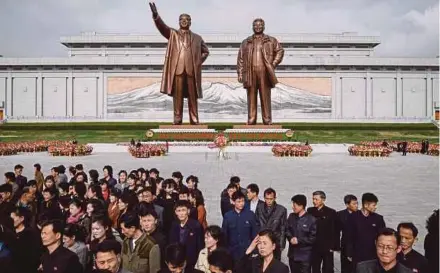  ?? AFP PIC ?? People leaving after paying their respects before the statues of late North Korean leaders Kim Il-sung and Kim Jong-il at Mansu Hill in Pyongyang yesterday.