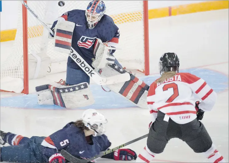  ?? — THE CANADIAN PRESS ?? Canada’s Meghan Agosta is stopped by U.S. goalie Alex Rigsby as Megan Keller looks on at the women’s world championsh­ips Monday in Kamloops.