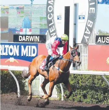  ?? Picture: JUSTIN KENNEDY ?? Jockey Brendon Davis crosses the finish line on Gary Clarke's The Captain to win the $20,500 Mantra Handicap at Fannie Bay yesterday