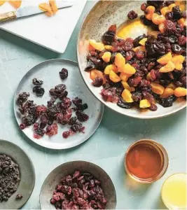  ?? ?? Dried fruits, orange juice and rum are among the ingredient­s for a fruitcake. Macerating dried fruit in a combinatio­n of orange juice and rum serves as a kind of aging process.