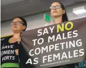  ?? JOHN BAZEMORE AP ?? Protesters hold signs as Penn transgende­r swimmer Lia Thomas competes in NCAA championsh­ips.