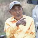  ??  ?? Navajo Code Talker William Tully Brown watches a parade in Window Rock. MARK HENLE/THE REPUBLIC