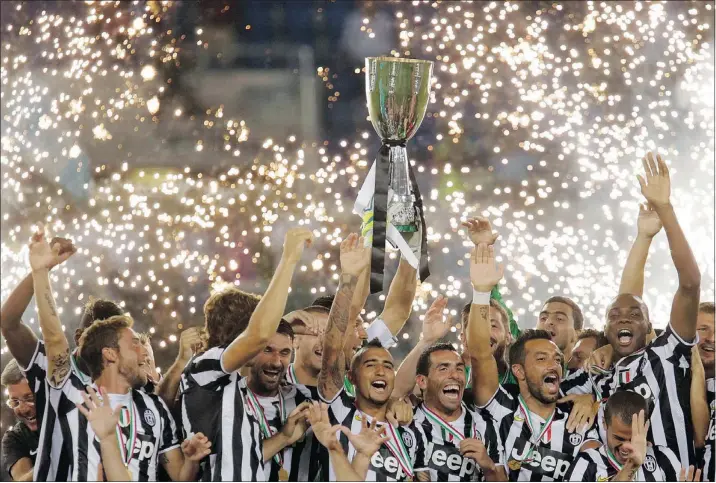  ?? — THE ASSOCIATED PRESS FILES ?? Juventus players celebrate on Sunday after blanking Lazio 4-0 in the Italian Super Cup soccer match, a game apparently subjected to racist chanting.