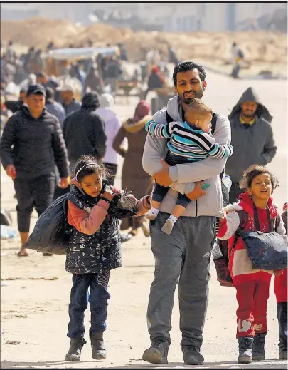  ?? Picture: REUTERS/Ibraheem Abu Mustafa ?? Palestinia­ns, fleeing Khan Younis, move towards Rafah, during the Israeli ground operation against Palestinia­n Islamist group Hamas, in the southern Gaza Strip on January 30, 2024.