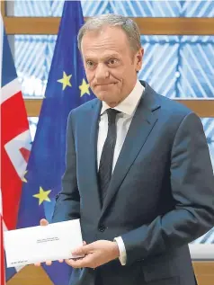  ?? Picture: AP. ?? EU Council president Donald Tusk holds Prime Minister Theresa May’s letter triggering Article 50.