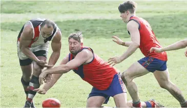  ??  ?? Above: Nyora coach Fia Tootoo attempts to collect the ball as Buln Buln’s Bryce Monahan treis to spoil.