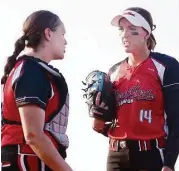  ?? David H opper ?? Pitcher Monica Abbott talks strategy with catcher Megan May Whitley before the Scrapyard Dawgs, Houston’s new pro softball team, first home game at the Scrap Yard Sports Complex, 29607 Robinson Road in Spring.