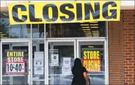  ?? Jeff Roberson Associated Press ?? STATES HAVE begun reopening their economies, but activity is returning very gradually. A full recovery could take years. Above, a store in St. Charles, Mo.