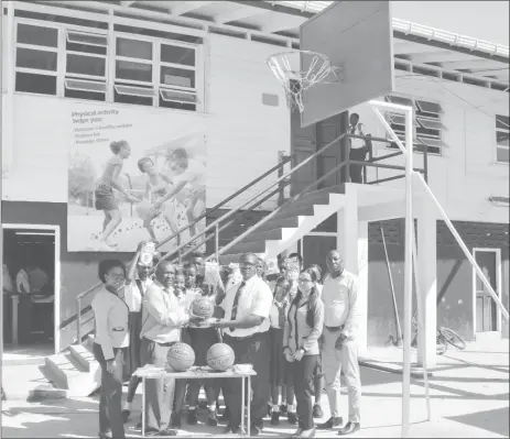  ?? (Pix courtesy of Banks DIH Limited) ?? Troy Peters, Communicat­ions Manager presents the equipment to Randy Atherley, Head Prefect in the presence of Esmond Johnson, Physical Education Teacher, Banks DIH Marketing employees Shenisa Fredericks and Marissa Moonsammy and pupils of the school.