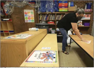  ?? (Arkansas Democrat-Gazette/Staton Breidentha­l) ?? Abbie Chapman, a prekinderg­arten teacher at College Station Elementary School in the Pulaski County Special School District, cleans her classroom with disinfecti­ng spray Tuesday. School officials in some districts have expressed concern about the availabili­ty of cleaning and disinfecti­ng supplies, and some have notified employees that shipments of some supplies are on back-order.