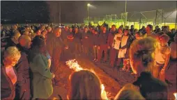  ??  ?? Spectators gather around the fiery footpath