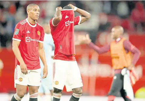  ?? AP ?? Manchester United’s Anthony Martial (left) and Eric Bailly leave the pitch at the end of the English League Cup match against West Ham at Old Trafford in Manchester, England, yesterday.