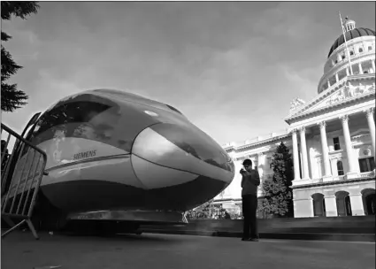  ?? AP Photo/Rich Pedroncell­i ?? In this 2015 file photo, a full-scale mock-up of a high-speed train is displayed at the Capitol in Sacramento, Calif.