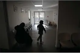  ?? CHRISTOPHE ENA — THE ASSOCIATED PRESS ?? A child and his mother wait at the reception area in the pediatric unit of the Robert Debre hospital in Paris, France, on Tuesday.
