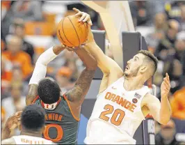  ?? NICK LISI / ASSOCIATED PRESS ?? Syracuse’s Tyler Lydon blocks a shot from Miami’s Ja’Quan Newton, who scored eight points, about eight below his average, on 3 of 12 shooting.