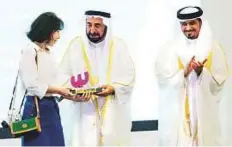  ??  ?? Dr Shaikh Sultan honours one of the winners of the Illustrati­ons awards in the presence of Ahmad Al Ameri. WAM