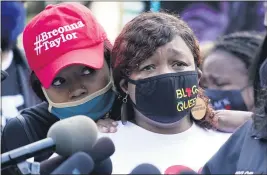  ?? DARRON CUMMINGS — THE ASSOCIATED PRESS ?? Tamika Palmer, the mother of Breonna Taylor, right, listens to a news conference on Friday in Louisville, Ky.