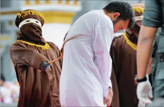  ??  ?? An Indonesian man ( center), one of two to be publicly caned for having sex, is caned in Banda Aceh on Tuesday. The pair, aged 20 and 23, were found guilty of having broken sharia rules in conservati­ve Aceh province – the only part of Indonesia that...