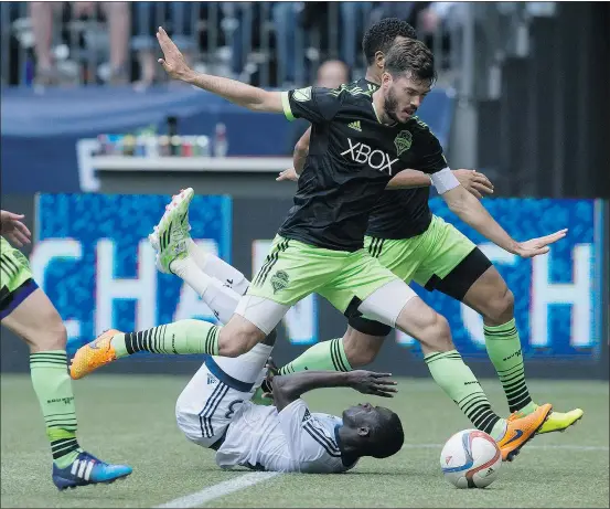  ?? — CP ?? Vancouver Whitecaps forward Kekuta Manneh gets run off the ball by Seattle Sounders’ Brad Evans during Saturday’s game.