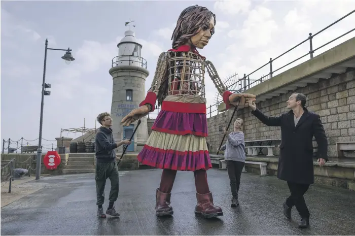  ?? Getty ?? British actor Jude Law was on hand to greet Little Amal, a 3.5-metre-tall puppet representi­ng a Syrian refugee girl aged 9, when she arrived in Kent