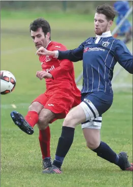  ??  ?? Helder Goncalves makes a clearance for Black Bull as Ardee Celtic’s Niall Eccles closes him down.