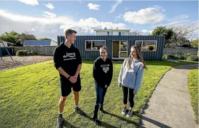  ?? DAVID UNWIN/STUFF ?? Students Daniel Mccracken, 17, Olivia de Groot, 18, and Olivia Feldberg, 18, run an afternoon school programme inside a shipping container.