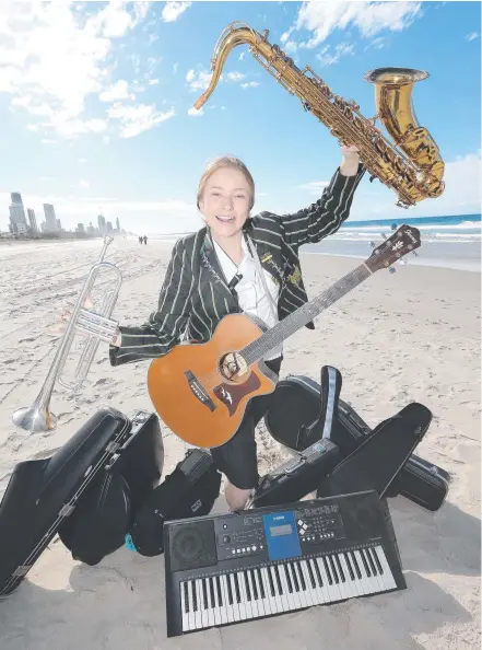  ?? Picture: MIKE BATTERHAM ?? Elliena Escott, of Trinity Lutheran College, with some of the 10 different instrument­s she can play.