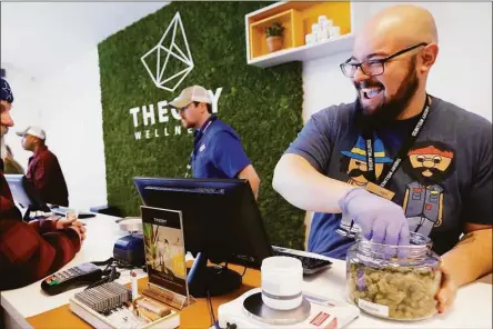  ?? Stephanie Zollshan / Contribute­d photo ?? Alex Premoli makes the first sale to a customer on the opening day of recreation­al marijuana sales at Theory Wellness in Great Barrington, Mass. on Jan. 11, 2019.