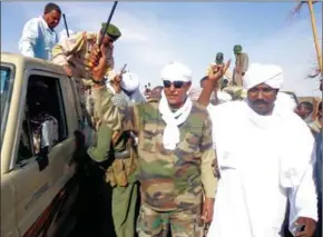  ?? AFP ?? Musa Hilal (centre), the leader of the Arab Mahamid tribe in Darfur, salutes his followers upon his arrival in Nyala on December 7, 2013.