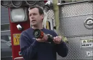  ?? MARK THIESSEN — THE ASSOCIATED PRESS ?? Senior Fire Captain Nick Davis demonstrat­es nozzles April 24to other firefighte­rs in Anchorage, Alaska, learning how to fight wildland fires.