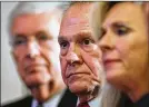  ?? BRYNN ANDERSON / AP ?? Roy Moore (center) “is against all threats against the traditiona­l family,” says one pastor who still backs him.