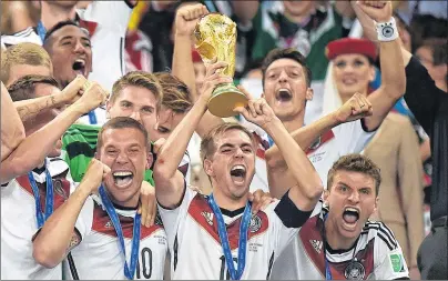  ?? AP PHOTO ?? In this July 13, 2014, file photo, Germany’s Philipp Lahm (16) raises the trophy after the World Cup final soccer match between Germany and Argentina at the Maracana Stadium in Rio de Janeiro, Brazil.
