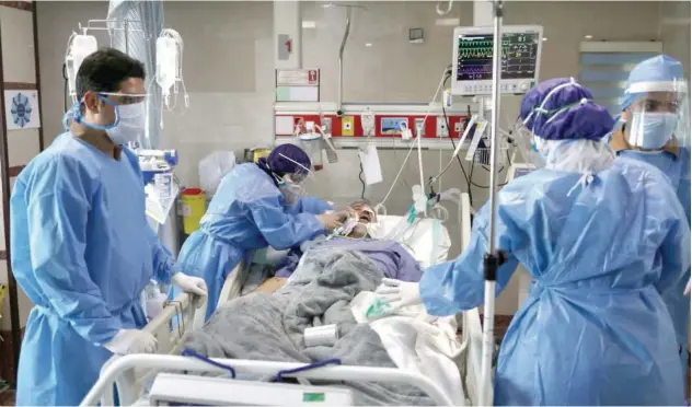  ?? Reuters ?? ↑
Nurses prepare a patient to be transferre­d to Masih Daneshvari Hospital in Tehran on Monday.
