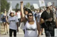  ?? ERIC GAY — THE ASSOCIATED PRESS ?? Diane Landers raises her fist as she chants during a march along a levee toward the Rio Grande to oppose the wall the U.S. government wants to build on the river separating Texas and Mexico, Saturday in Mission, Texas.