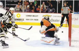  ?? JANE THERESE/SPECIAL TO THE MORNING CALL ?? Lehigh Valley Phantoms goalie Alex Lyon makes one of his 29 saves against the Hershey Bears Saturday at PPL Center in Allentown.