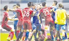  ??  ?? A brawl erupting between Shanghai SIPG players and Guangzhou R&amp;F players, as Shanghai’s Oscar lies on the ground, during their Chinese Super League football match in Guangzhou in China’s southern Guangdong province in this June 18, 2017 file photo. — AFP photo