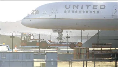  ?? Brian van der Brug Los Angeles Times ?? A PART from a United Airlines jet struck a car in Newport Beach last month. The FAA is investigat­ing. Above, a United plane in 2014.