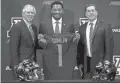  ?? MIKE CHRISTY/ARIZONA DAILY STAR ?? New Arizona coach Kevin Sumlin (center) poses with UA President Robert Robbins (left) and AD Dave Heeke.