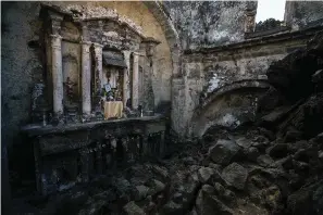  ?? The Associated Press ?? An altar adorned with religious relics stands inside a church buried decades ago by lava from the Paricutin volcano on Feb. 21 in San Juan Parangaric­utiro, Mexico.