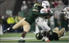  ?? DAVID ZALUBOWSKI — THE ASSOCIATED PRESS ?? Boise State running back Ashton Jeanty, center, is stopped by Colorado State defensive lineman Mohamed Kamara, left, and defensive back Dominic Morris in the second half on Oct. 14in Fort Collins.