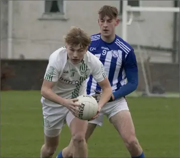  ??  ?? Three-goal hero Tomás Murphy gets to the ball ahead of Counsel midfielder Mark Kehoe.