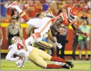  ?? CHARLIE RIEDEL — ASSOCIATED PRESS ?? Lorenzo Jerome upends Chris Conley after the Chiefs receiver catches a pass during the preseason opener.