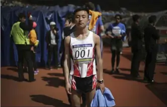  ??  ?? Pak Chol, 27, a profession­al long-distance runner, poses for a portrait after winning the Pyongyang marathon. Pak has won three marathons. His motto: “I want to please leader Kim Jong Un through my sporting successes.”