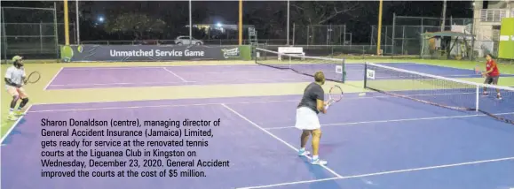  ??  ?? Sharon Donaldson (centre), managing director of General Accident Insurance (Jamaica) Limited, gets ready for service at the renovated tennis courts at the Liguanea Club in Kingston on Wednesday, December 23, 2020. General Accident improved the courts at the cost of $5 million.